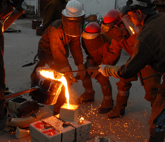 people pouring iron