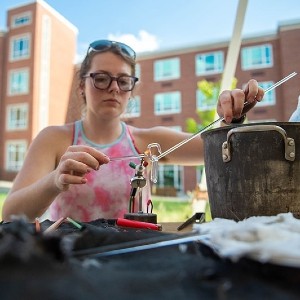 SIU student demonstrating glass demo 