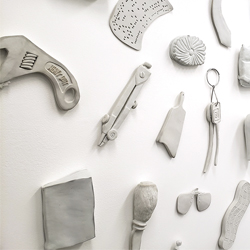 distrorted porcelain objects on a white wall