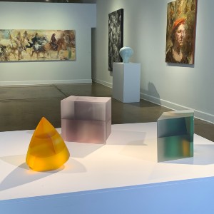 cube-like sculptures that are yellow, purple, and turquoise