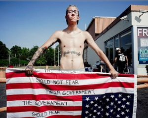 Ruddy Roye Photo of a young tatooed man with an american flag